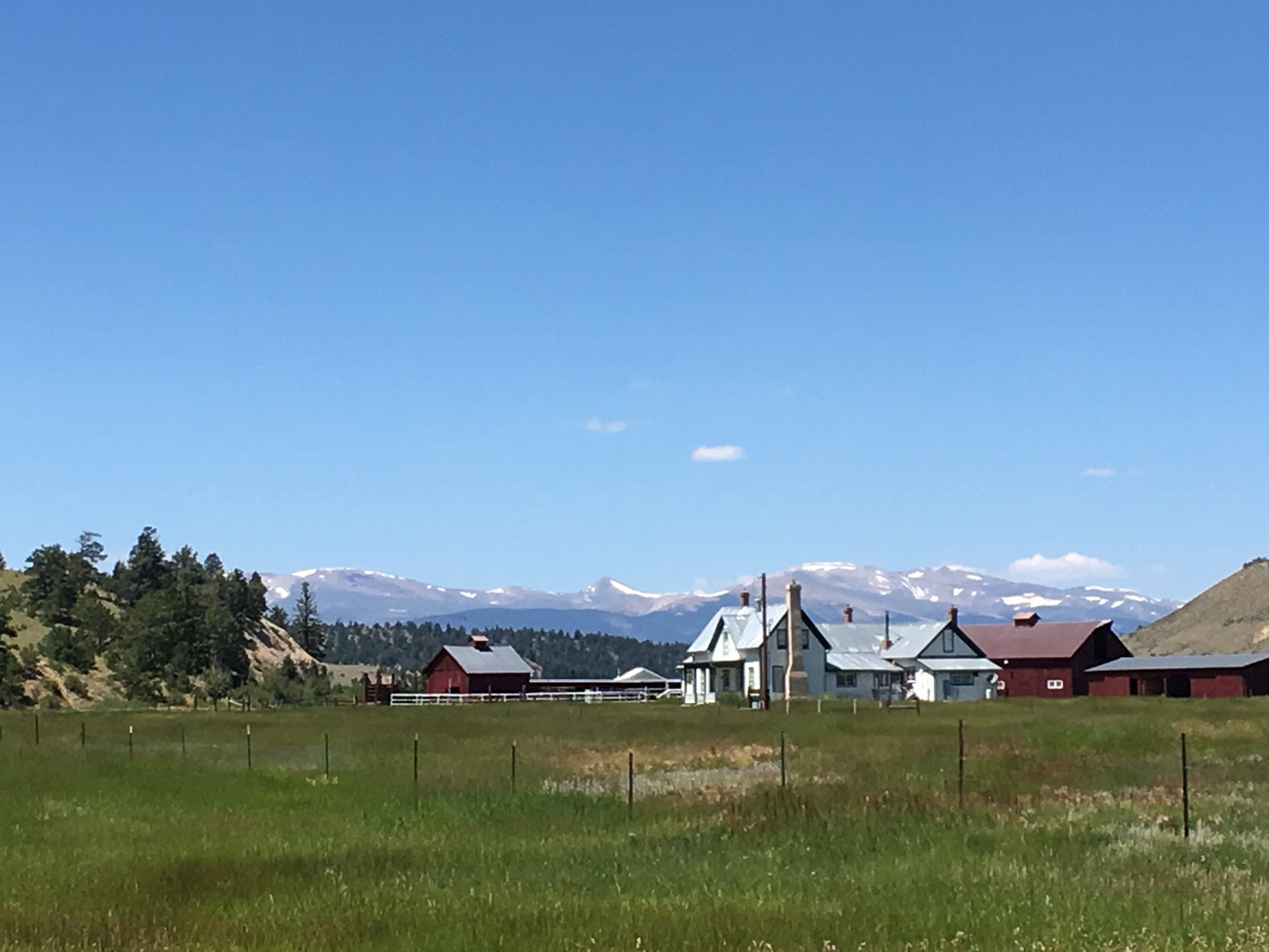 A historic ranch in an open mountain valley