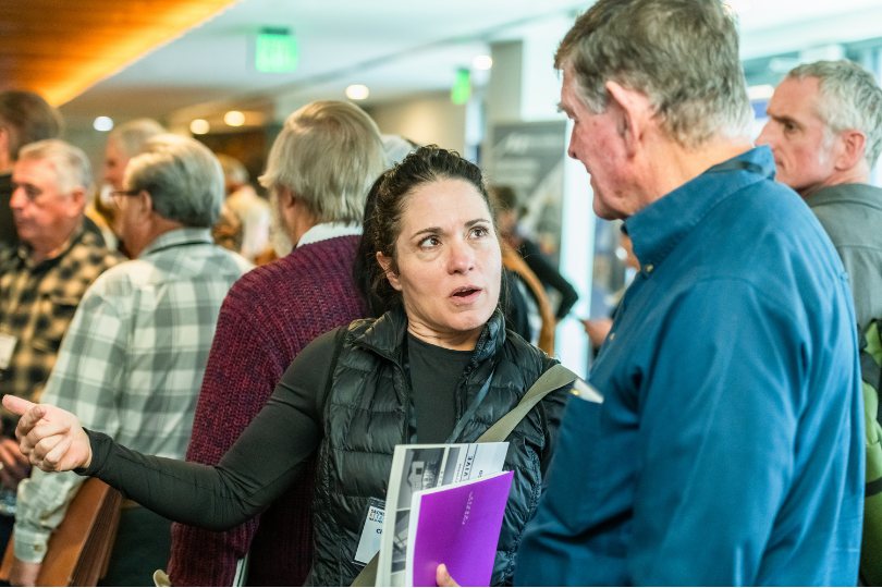 People in conversation at a community meeting